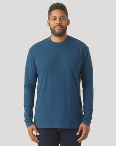 True ClassicPerson in Deep Sea Blue Long Sleeve T-Shirt, relaxed arms, dark pants.