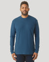 Person in Deep Sea Blue Long Sleeve T-Shirt, relaxed arms, dark pants.