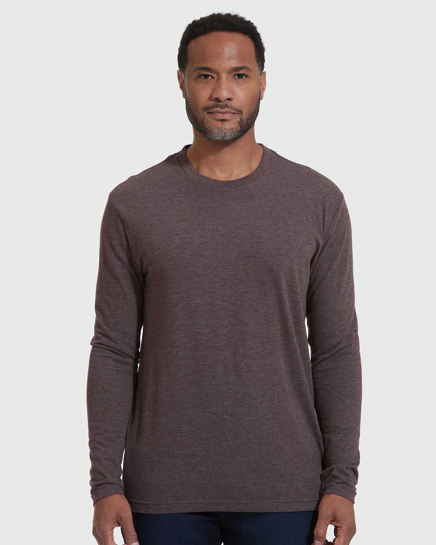 Man wearing Heather Dark Oak Classic Long Sleeve Crew Neck, standing neutrally.