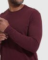 Mahogany Long Sleeve T Shirt on model adjusting sleeve.
