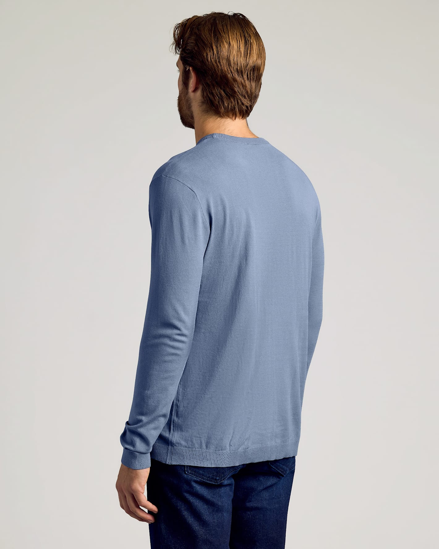 Fiord Dressy Crew Neck Sweater worn with dark jeans, back view.