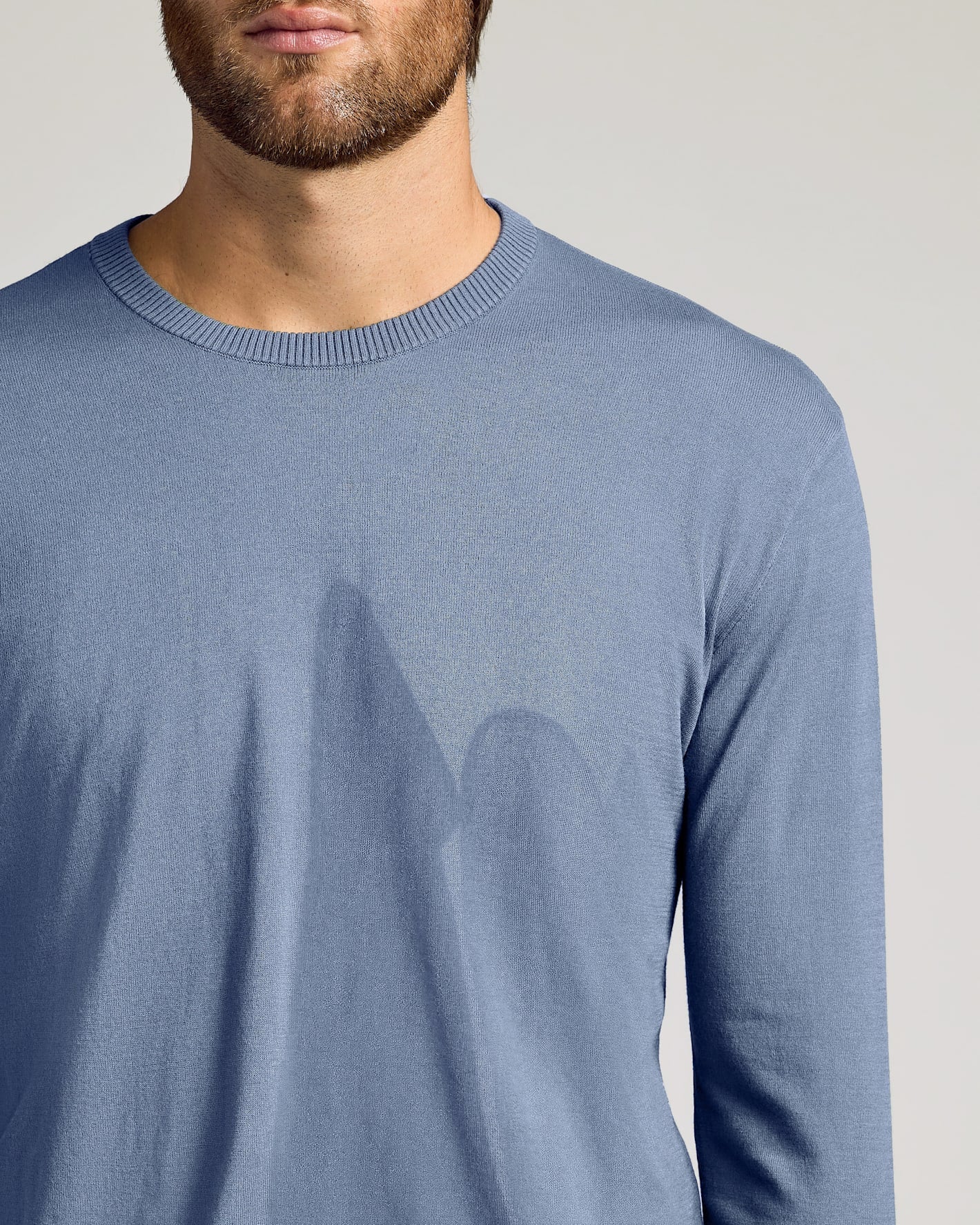 Fiord Dressy Crew Neck Sweater on man, showcasing slim fit.