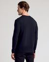 Man in All Black Classic Henley, showcasing fit and comfort.