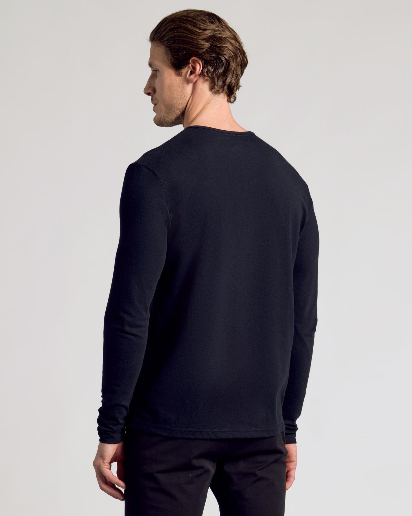 Man in All Black Classic Henley 3-Pack, showing minimalist fit.