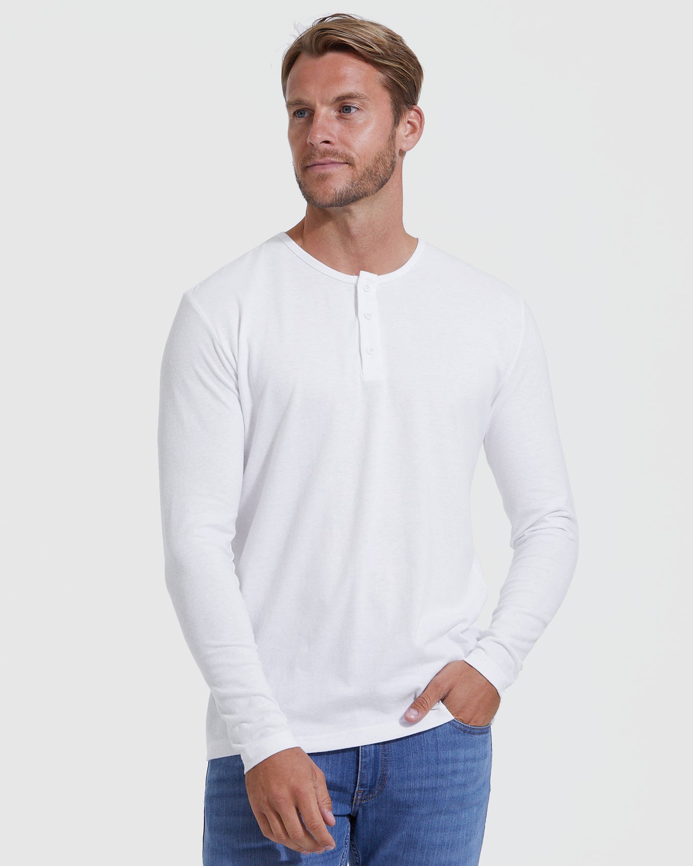 Man wearing All White Classic Henley from 6-Pack with blue jeans.
