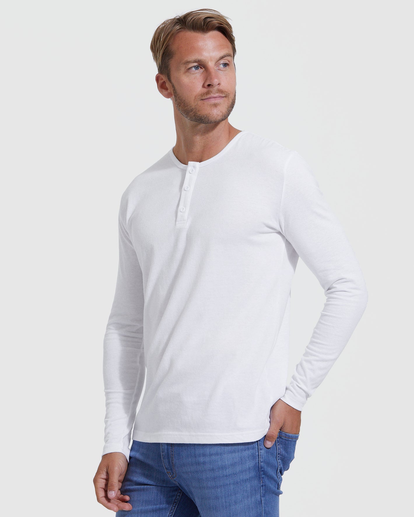 Model wearing All White Classic Henley, long-sleeve with jeans.