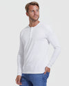 Man wearing a white long-sleeve shirt and blue jeans on a white background