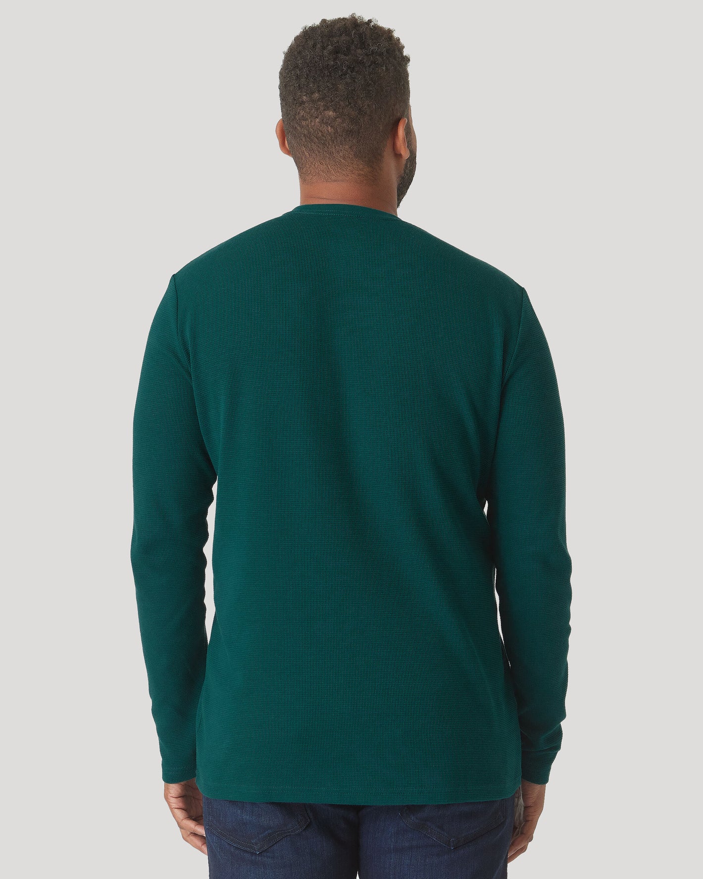 Man wearing Evergreen Heather Waffle Long Sleeve Crew Neck and dark jeans.