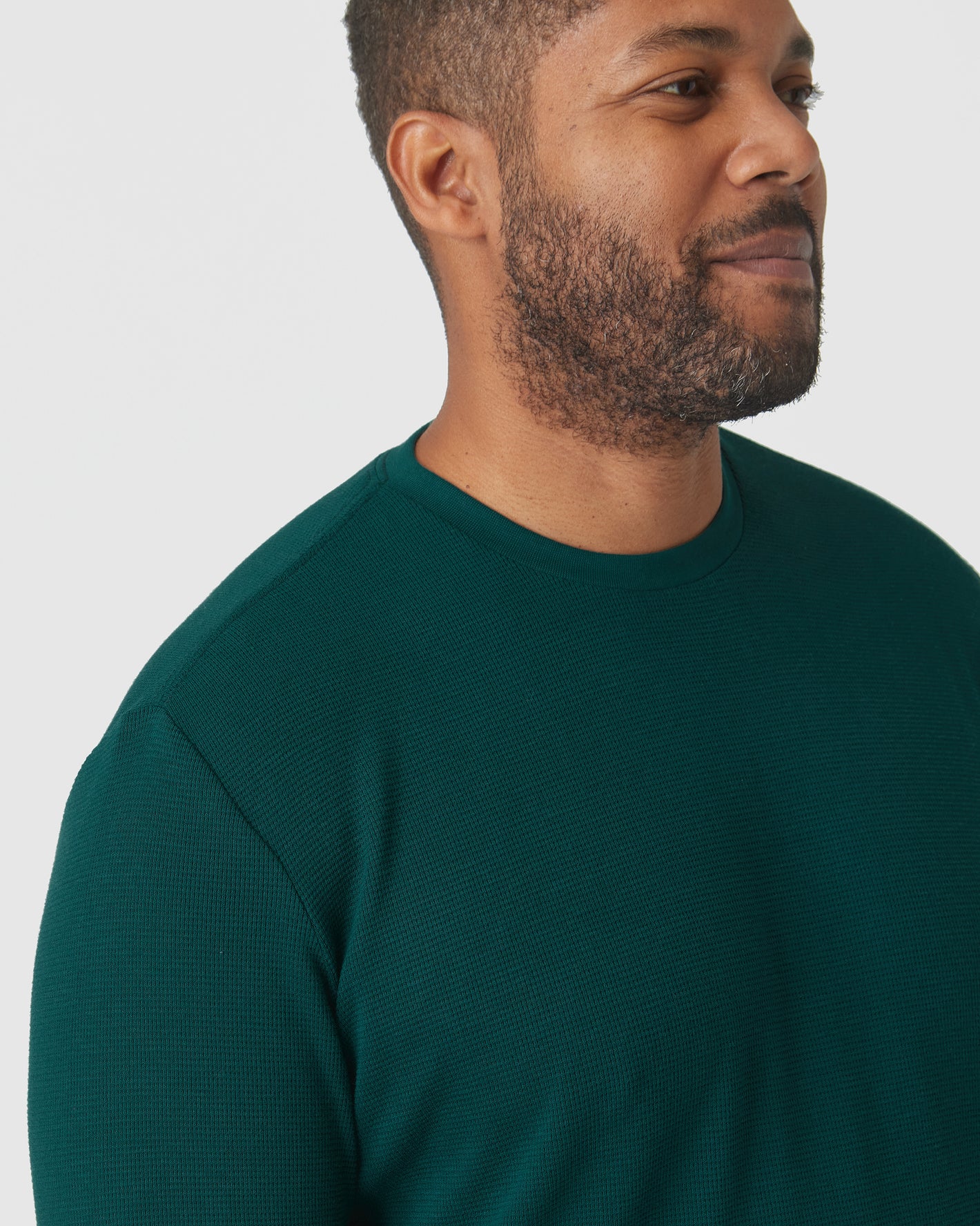 Man wearing Evergreen Heather Waffle Long Sleeve Crew Neck sweater.