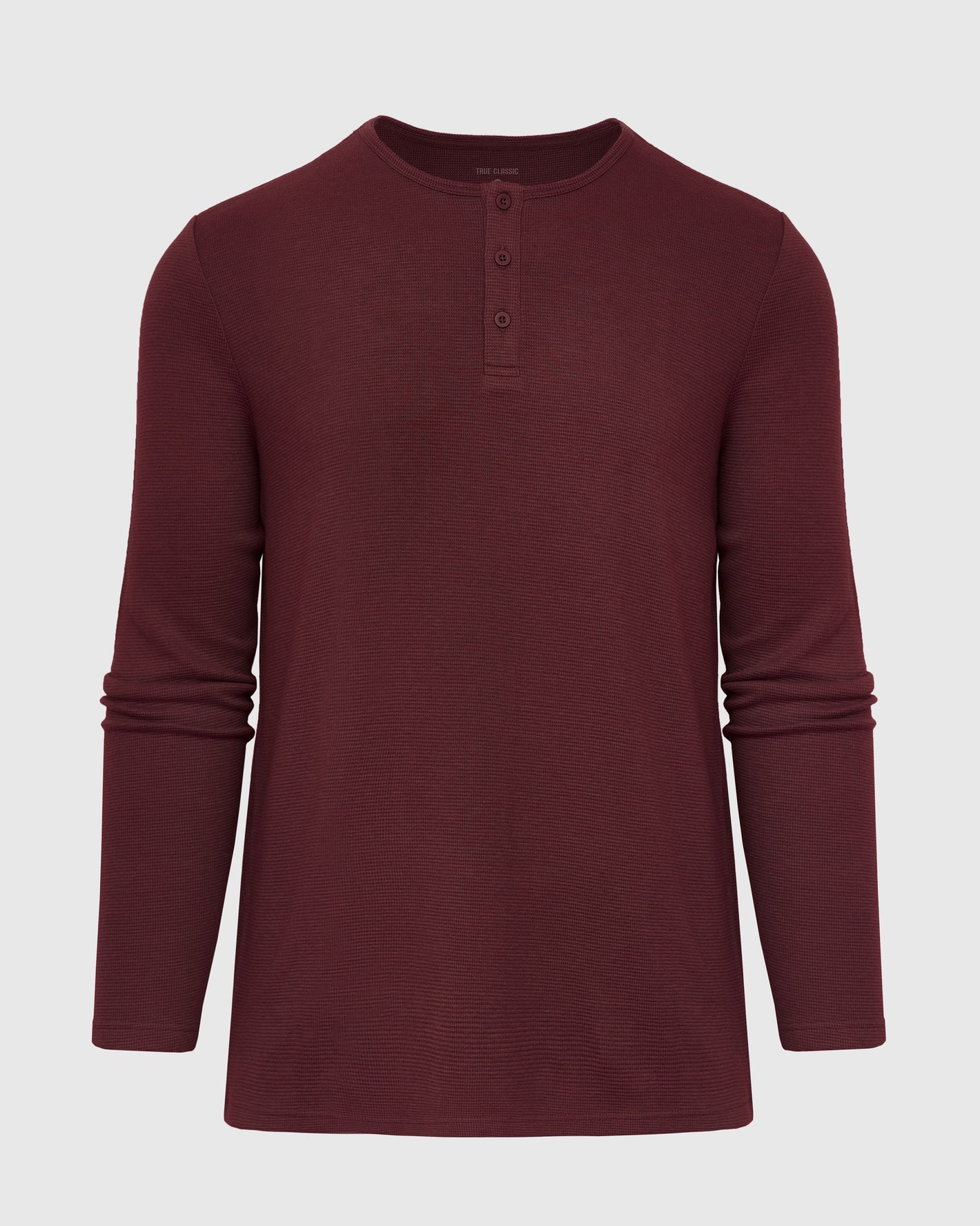 Mahogany Long Sleeve Waffle Henley with button placket and textured knit.