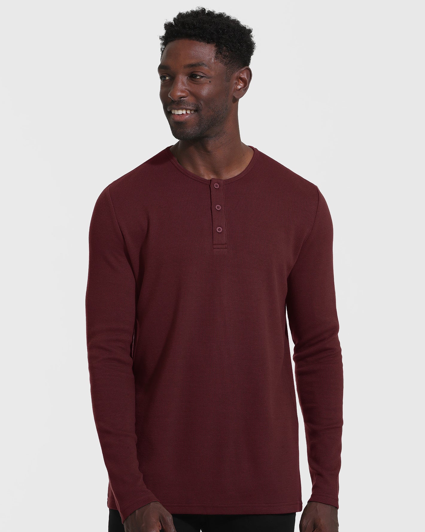 Mahogany Long Sleeve Waffle Henley on model against white background.