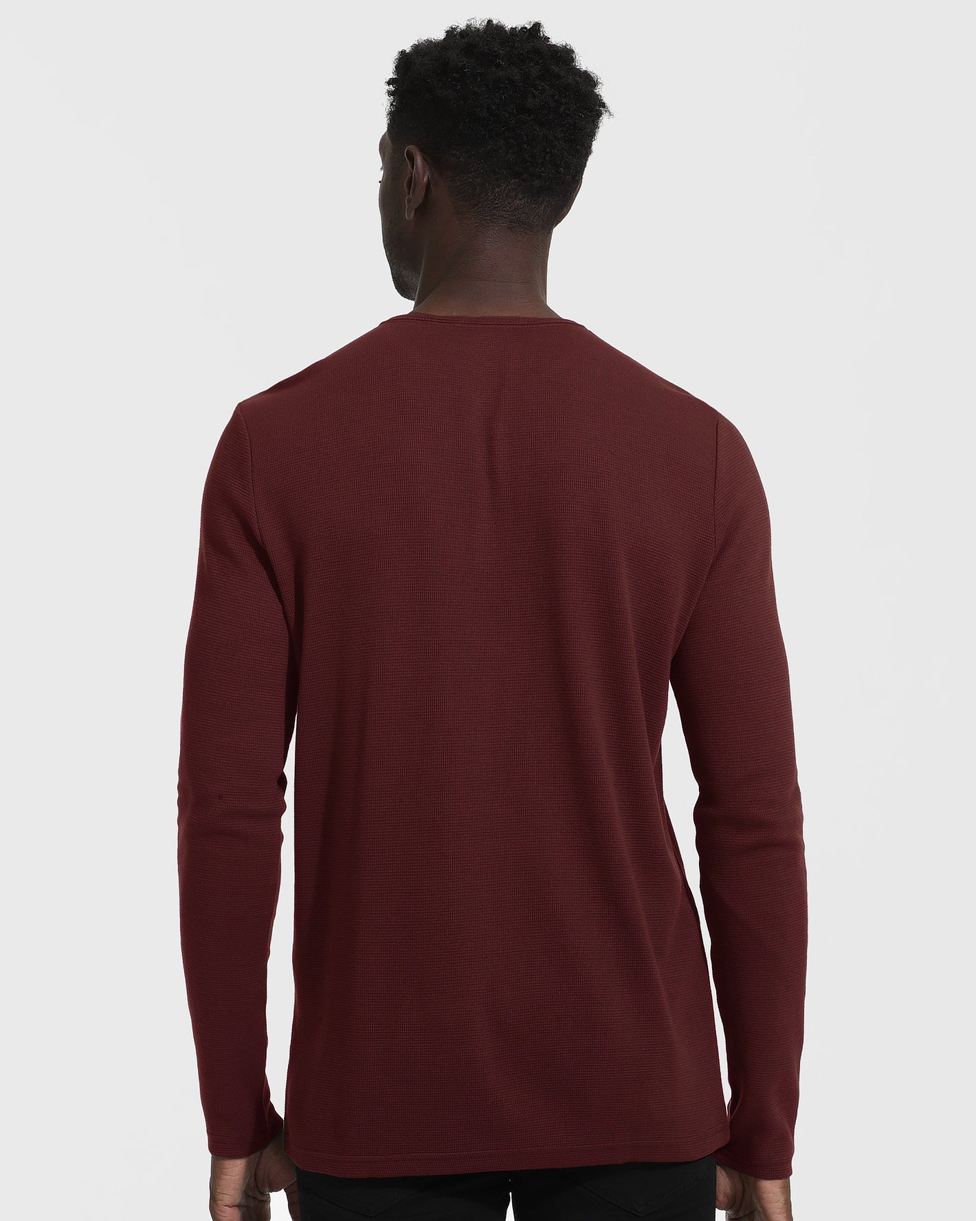 Back view of man wearing Mahogany Long Sleeve Waffle Henley.