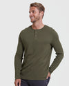 Model in Military Green Waffle Long Sleeve Henley and dark pants.