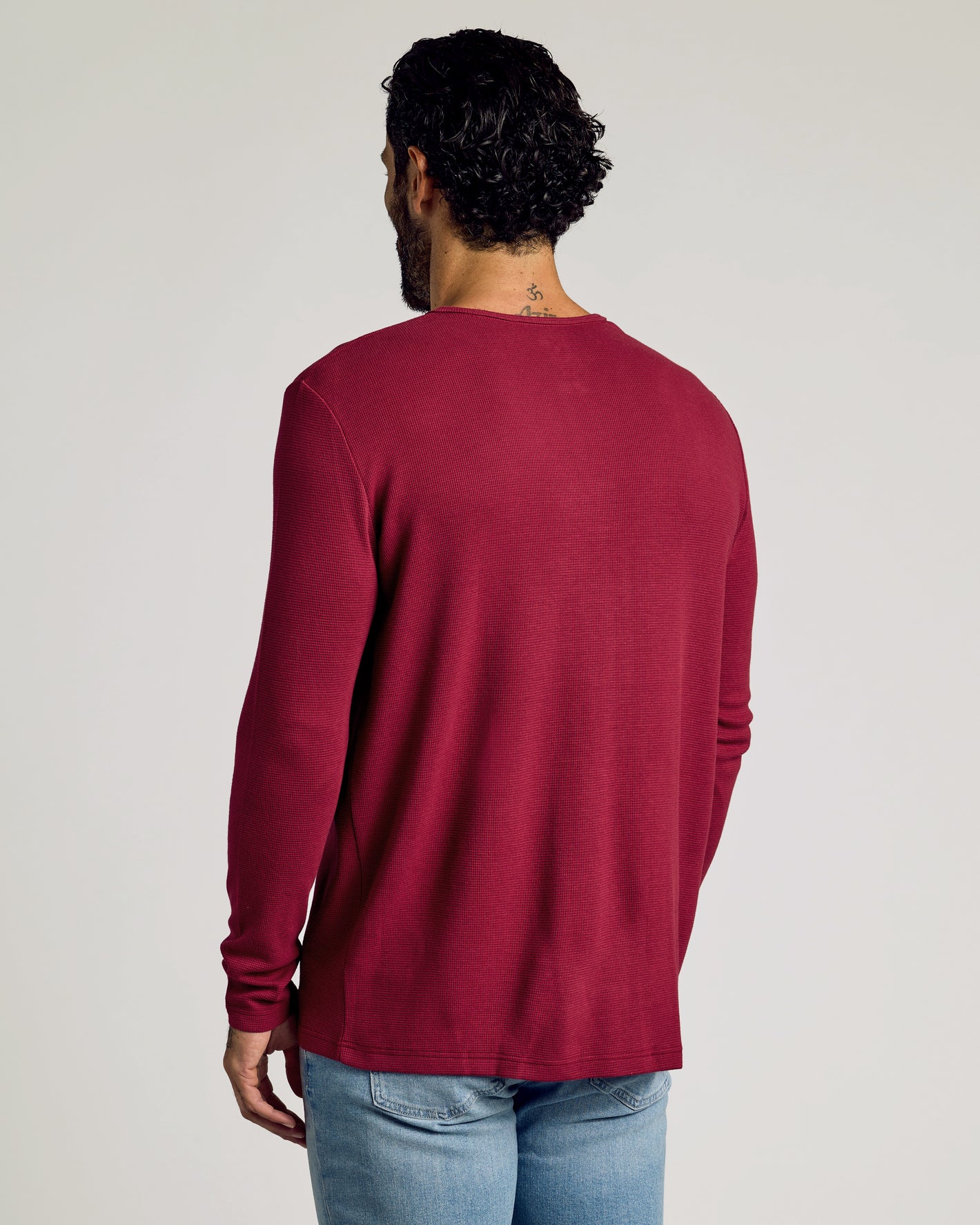 Man wearing Pinot Waffle Long Sleeve Henley with light-wash jeans.