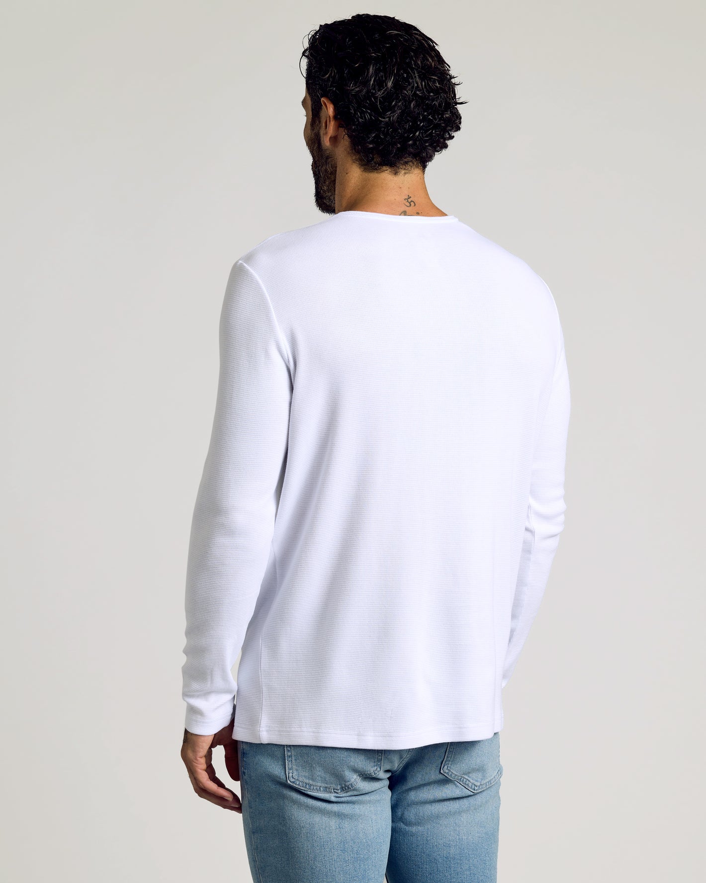 Man in White Waffle Long Sleeve Henley 3-Pack, back view.