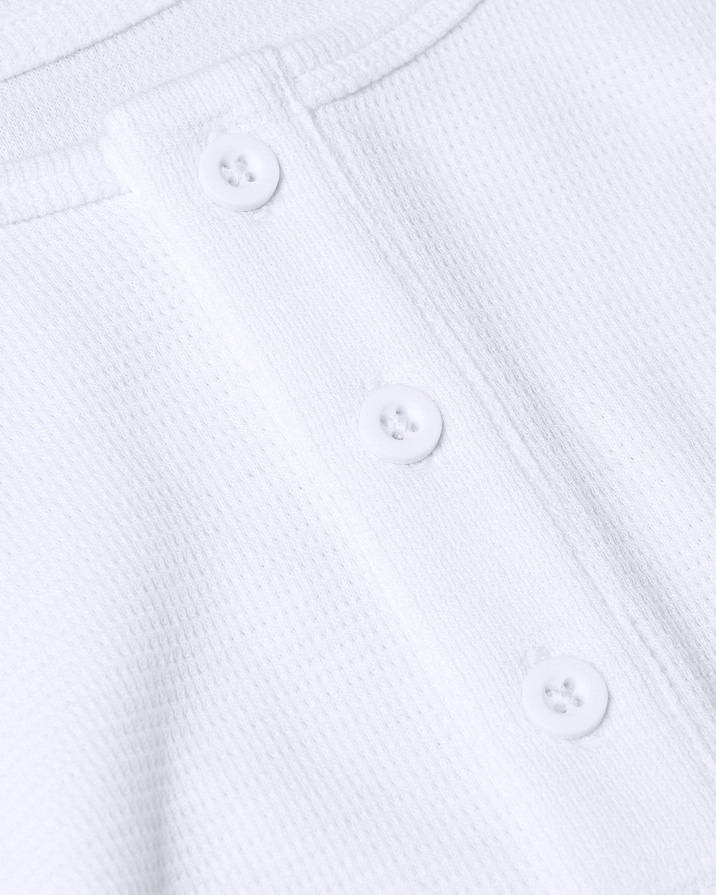 White Waffle Long Sleeve Henley with three-button placket detail.