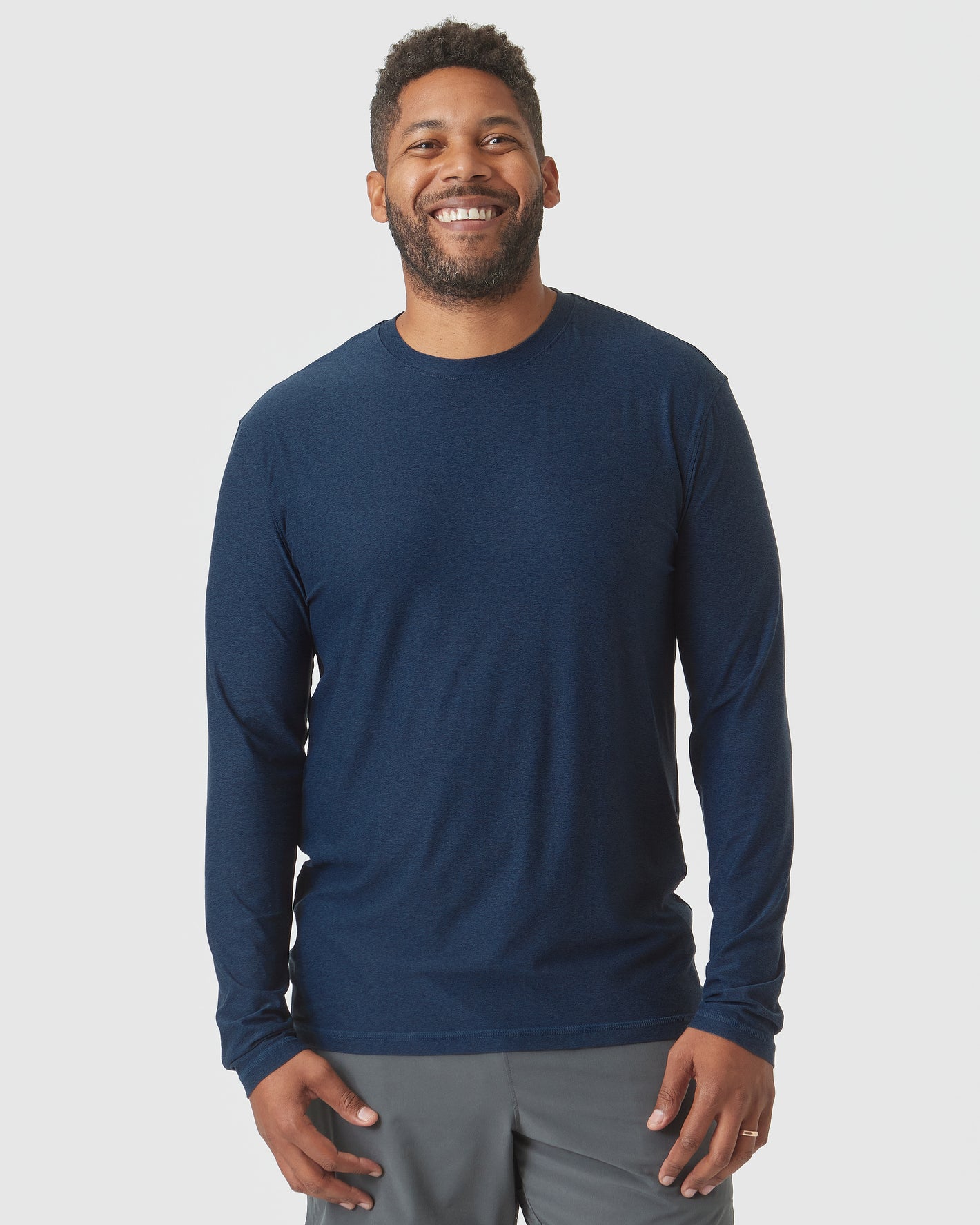 Man wearing Deep Sea Blue Heather Active Long Sleeve Crew T-Shirt.