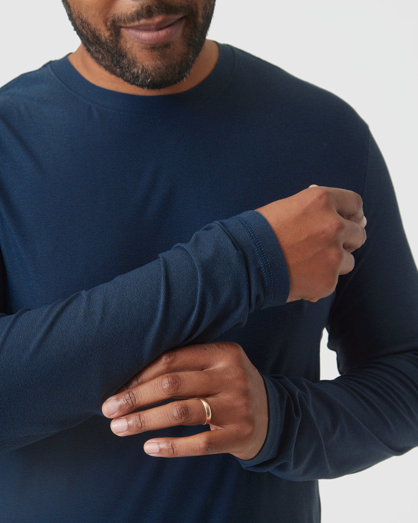 Person adjusting sleeve of Deep Sea Blue Heather Active Long Sleeve Crew T Shirt.