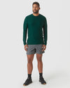 Man wearing Evergreen Heather Active Long Sleeve Crew T-Shirt with athletic shorts.