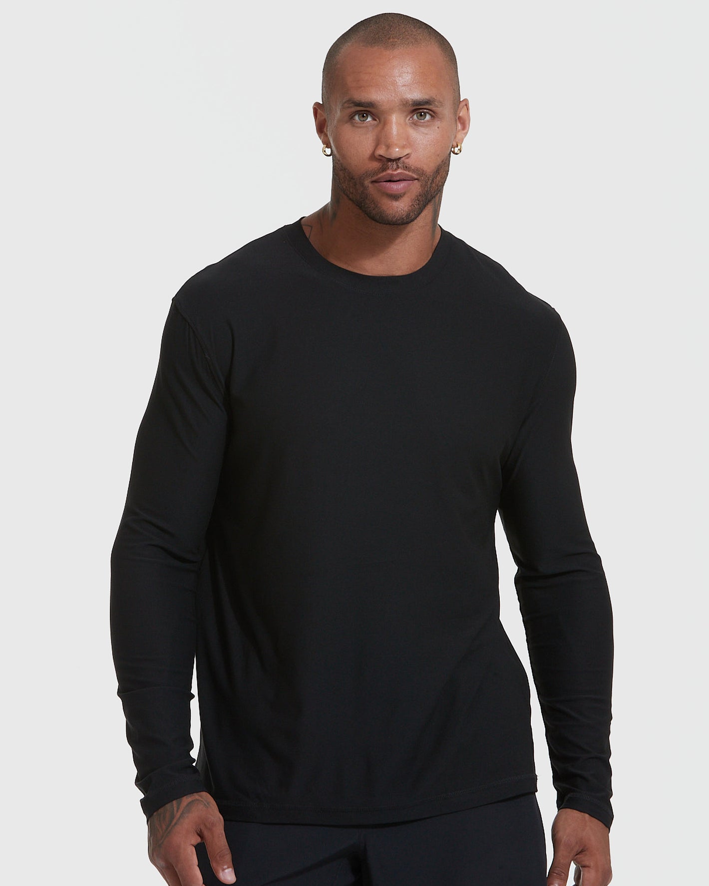 Man wearing Standard Active Long Sleeve Crew T-Shirt in black.