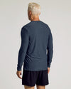 Man in Dark Heather Fiord Active Long Sleeve Crew T-Shirt, relaxed stance.