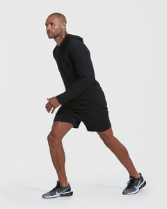 True ClassicMan wearing Black Active Hoodie, poised to sprint.