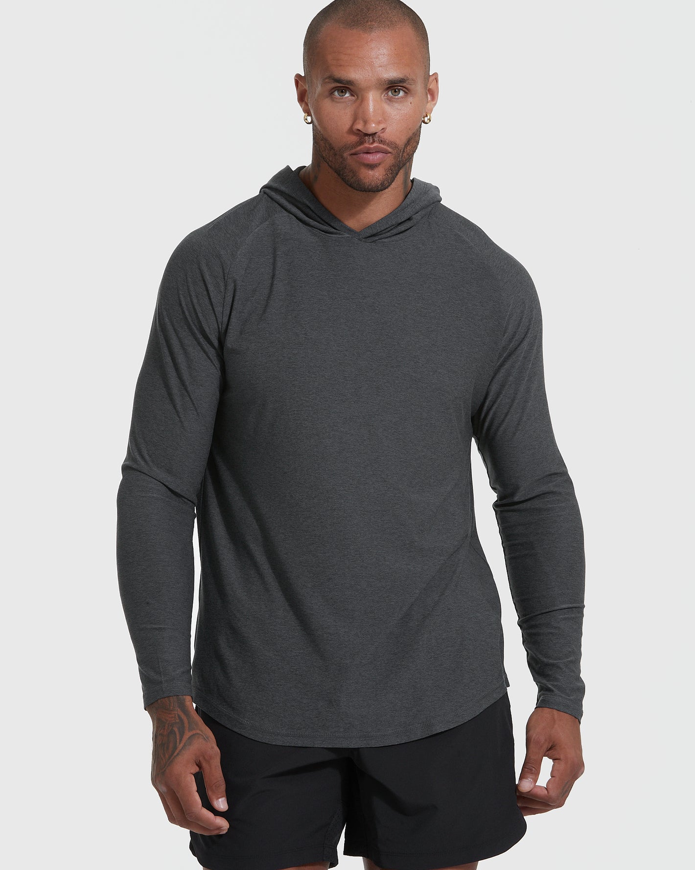 Man in Charcoal Heather Gray Active Hoodie and black athletic shorts.