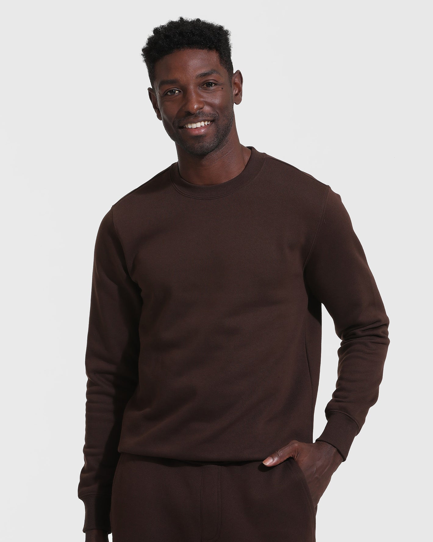 Man in Dark Oak Fleece French Terry Pullover Crew Neck.
