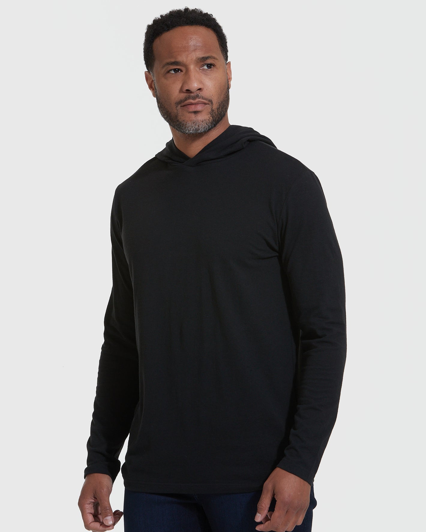 Black Hooded Long Sleeve T-Shirt on male model, plain background.
