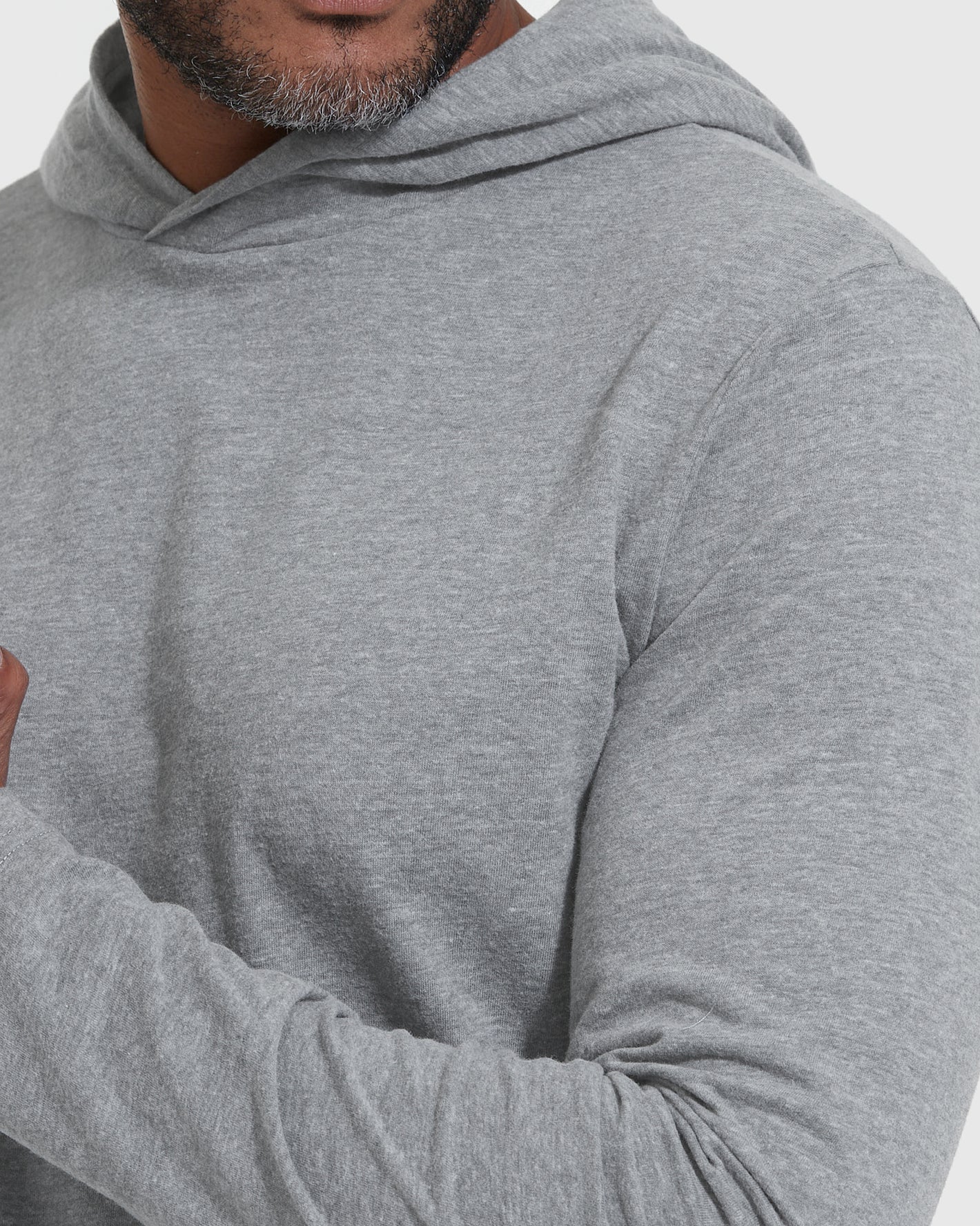 Heather Gray Hooded Long Sleeve T-Shirt worn by a model, arms crossed.