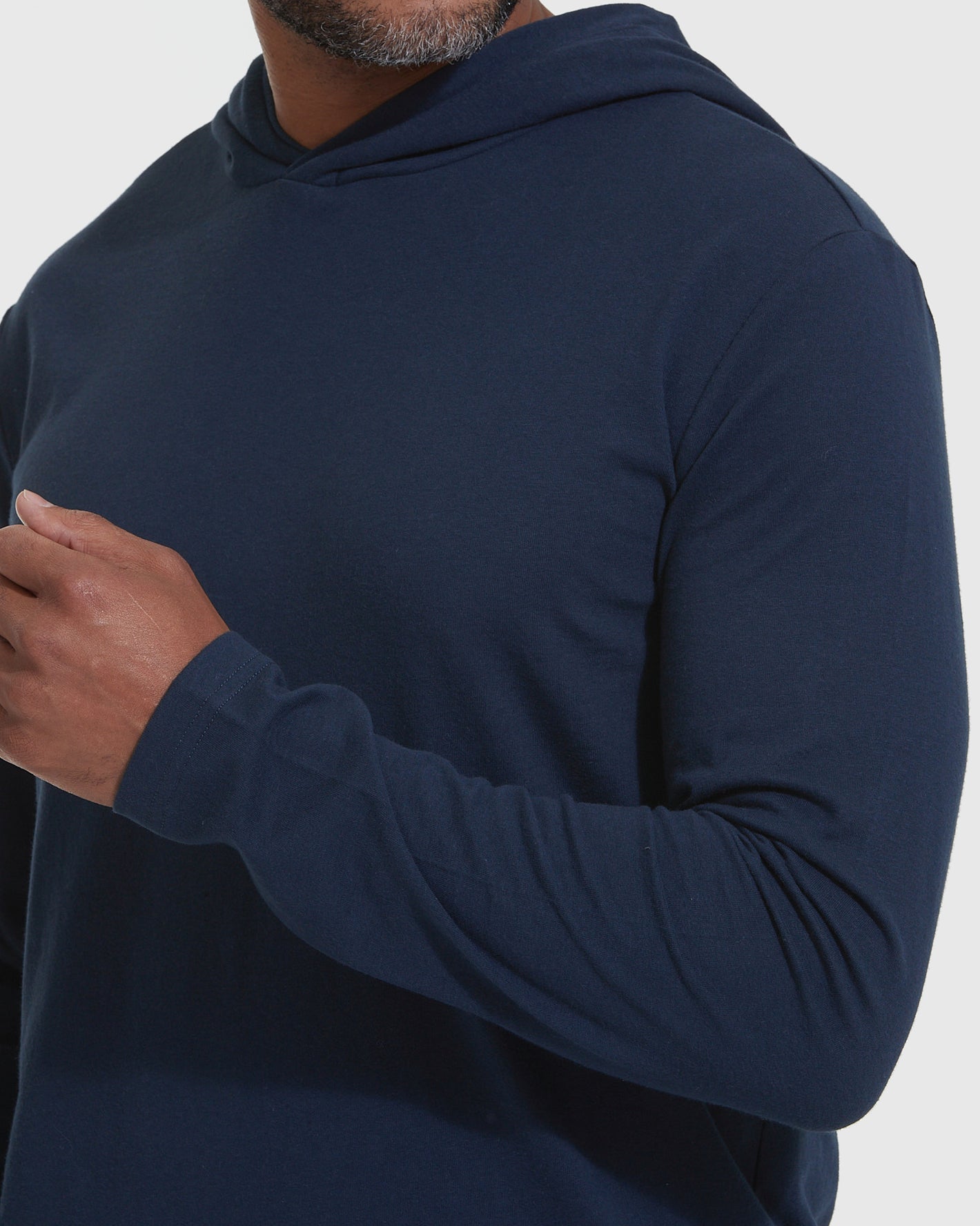 Person wearing Navy Hooded Long Sleeve T-Shirt, showcasing its lightweight, fitted design.