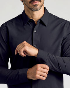 True ClassicBlack Commuter Long Sleeve Shirt with man adjusting cuffs, showcasing slim fit.