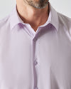 Man wearing Orchid Long Sleeve Lightweight Dress Shirt with undone top button.