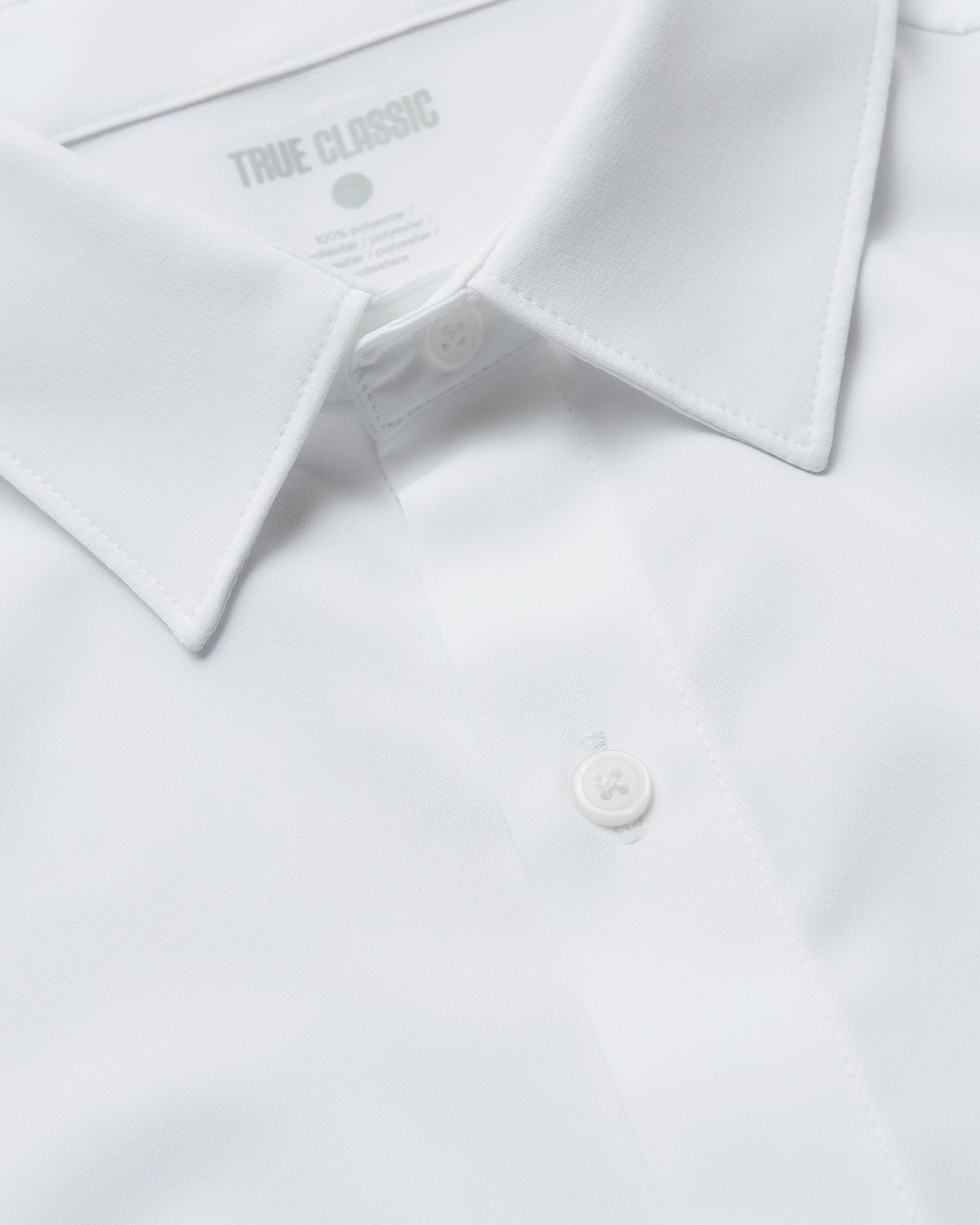 All White Long Sleeve Performance Dress Shirt with pointed collar and placket.