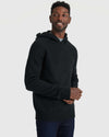 Man wearing Black Sweater Hoodie, layered over T-shirt, with jeans.