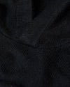 Black Sweater Hoodie showcasing ribbed texture and fabric folds.