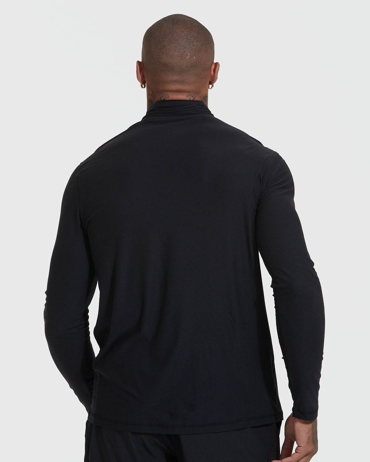 Man wearing Black Active Quarter Zip Shirt, back view.