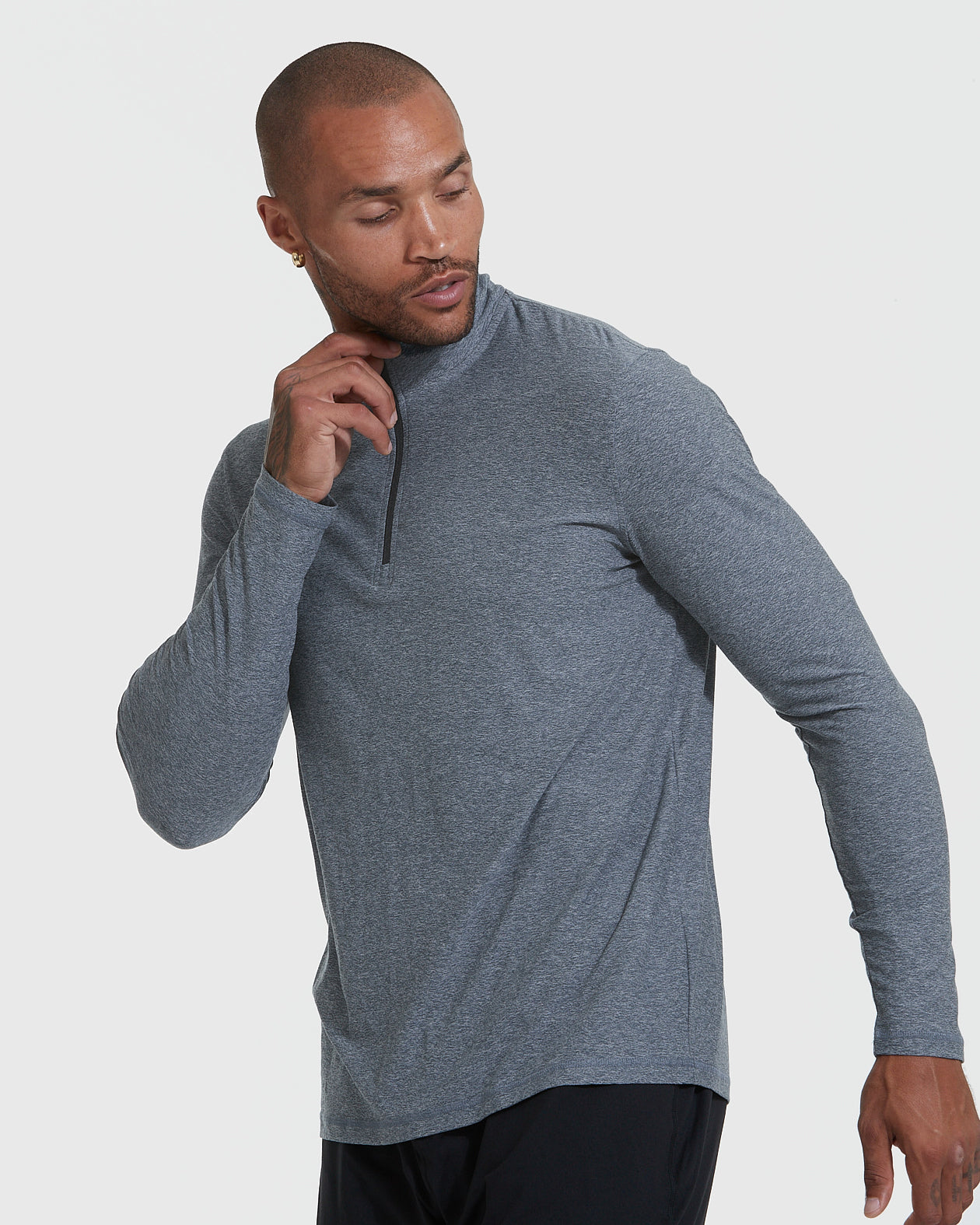 Man wearing Heather Navy Active Quarter Zip Shirt with black workout pants.