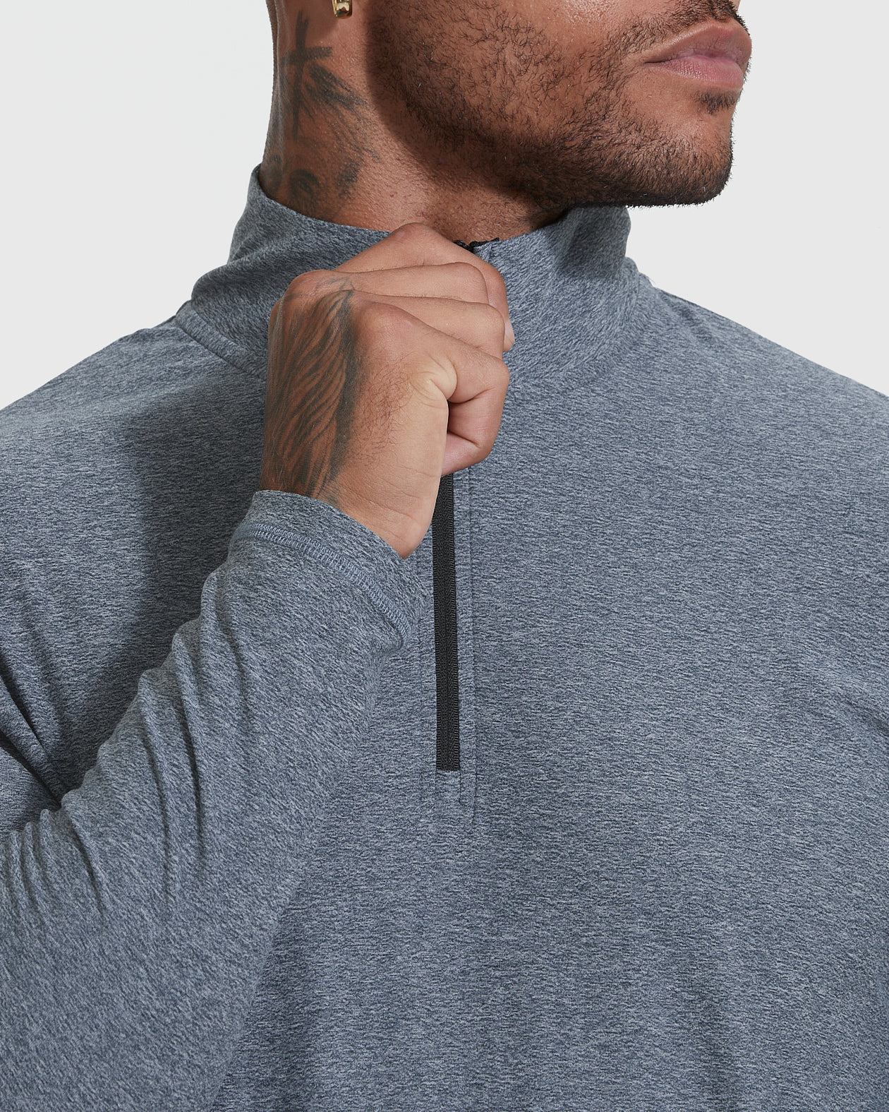 Heather Navy Active Quarter Zip Shirt being zipped by tattooed hand.