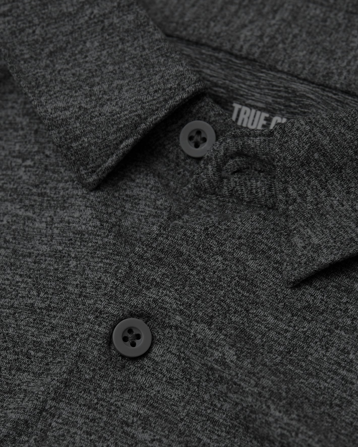 Close-up of Long Sleeve Do-It-All Comfort Shirt showing collar, button, and knit texture.