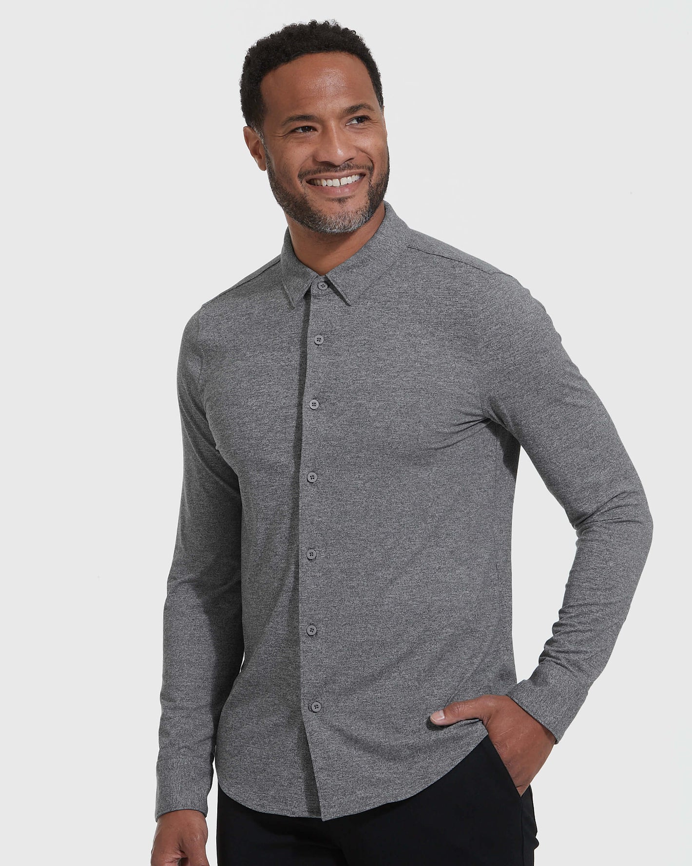 Man in Heather Gray Long Sleeve Do-It-All Comfort Shirt, smiling confidently.