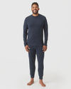 Man wearing Heather Navy Long Sleeve Loungewear Tee and jogger-style pants.