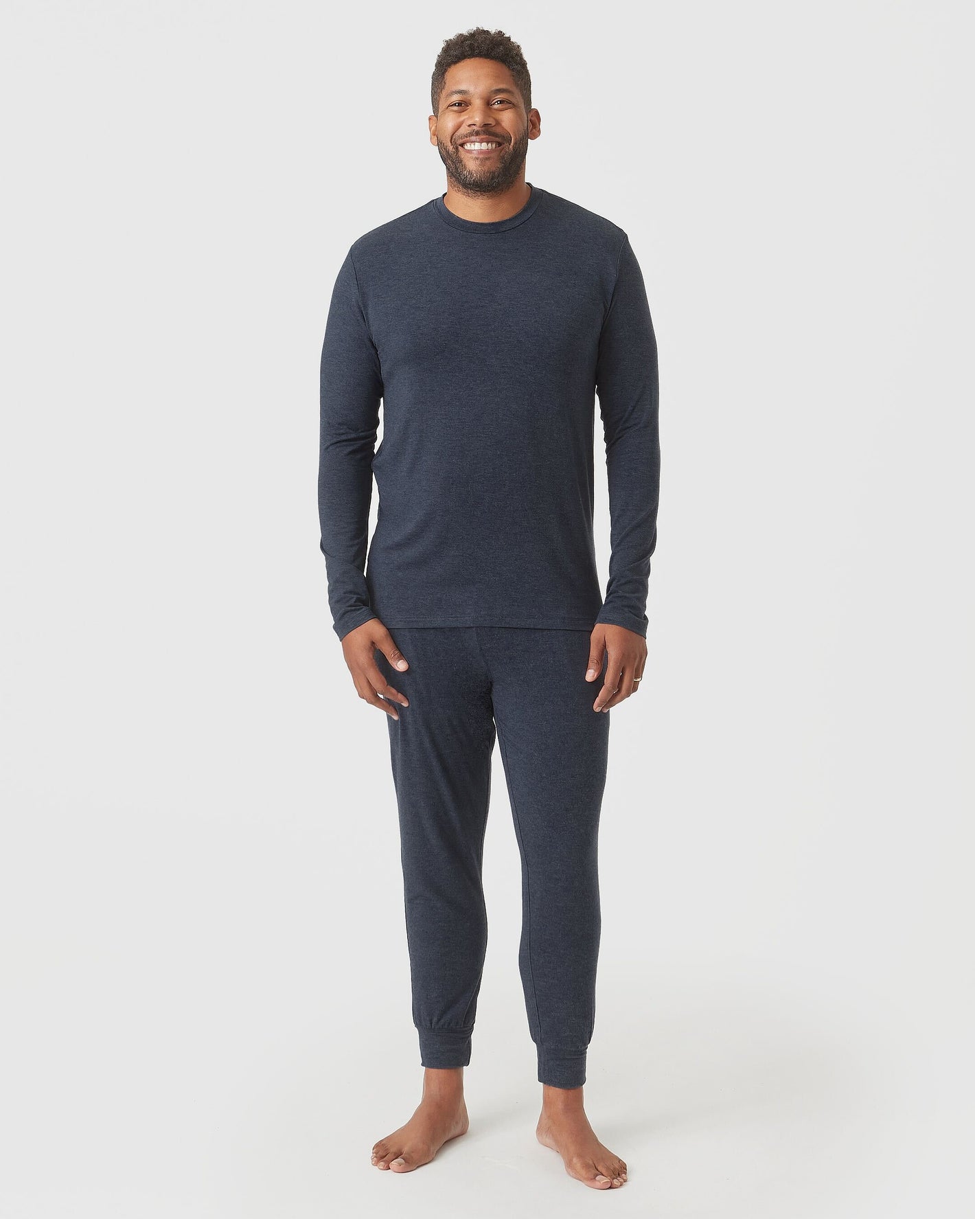 Man wearing Heather Navy Long Sleeve Loungewear Tee and jogger-style pants.