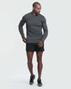 Man wearing Charcoal Heather Active Comfort Crew Sweatshirt, black shorts, and sneakers.