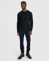 Man in Black Crew Neck Sweater, jeans, and Chelsea boots.