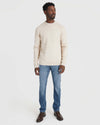 Man wearing Heather Oatmeal Crew Neck Sweater with blue jeans.