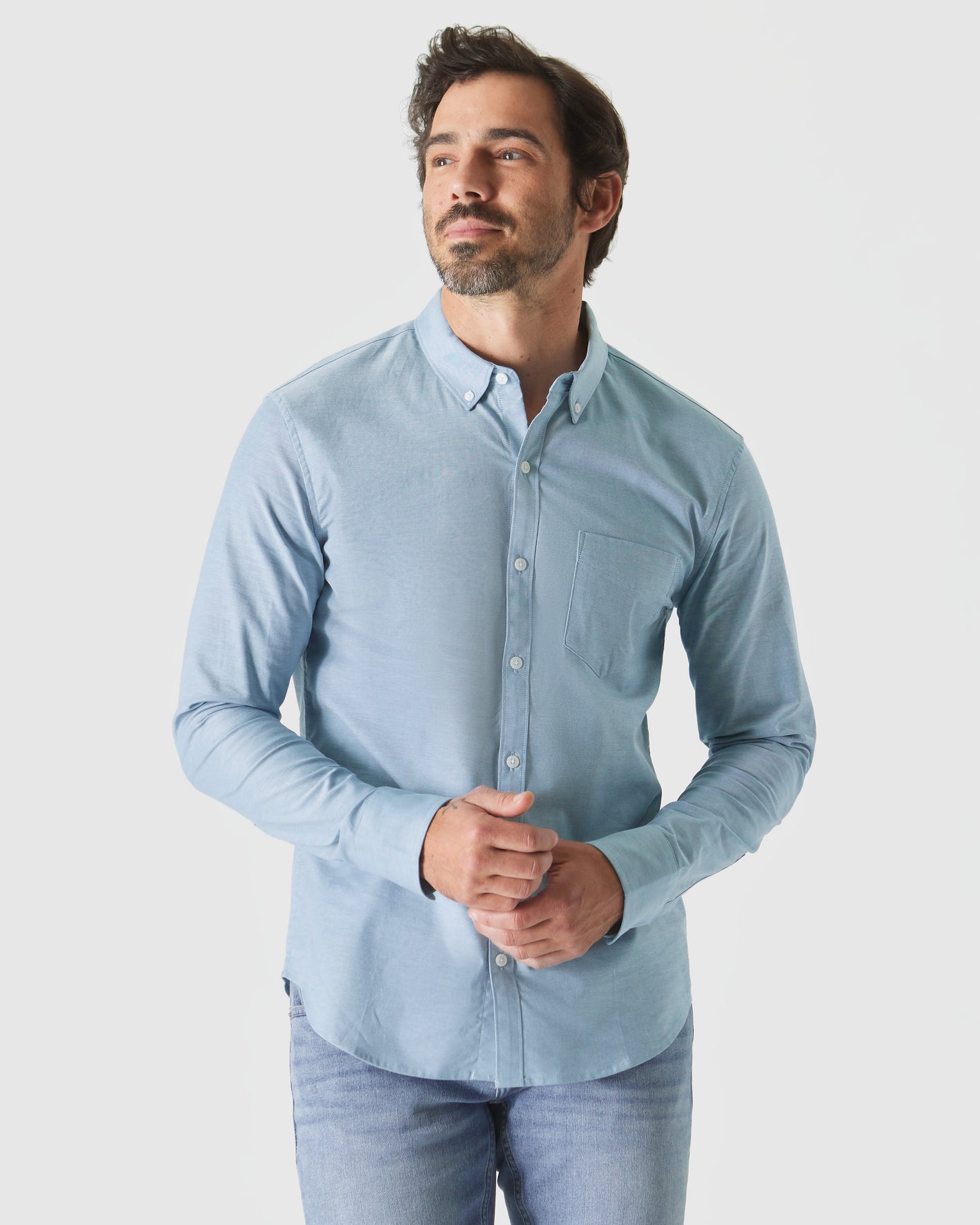 Harbor Stretch Oxford Long Sleeve Shirt on man, showcasing fit and comfort.