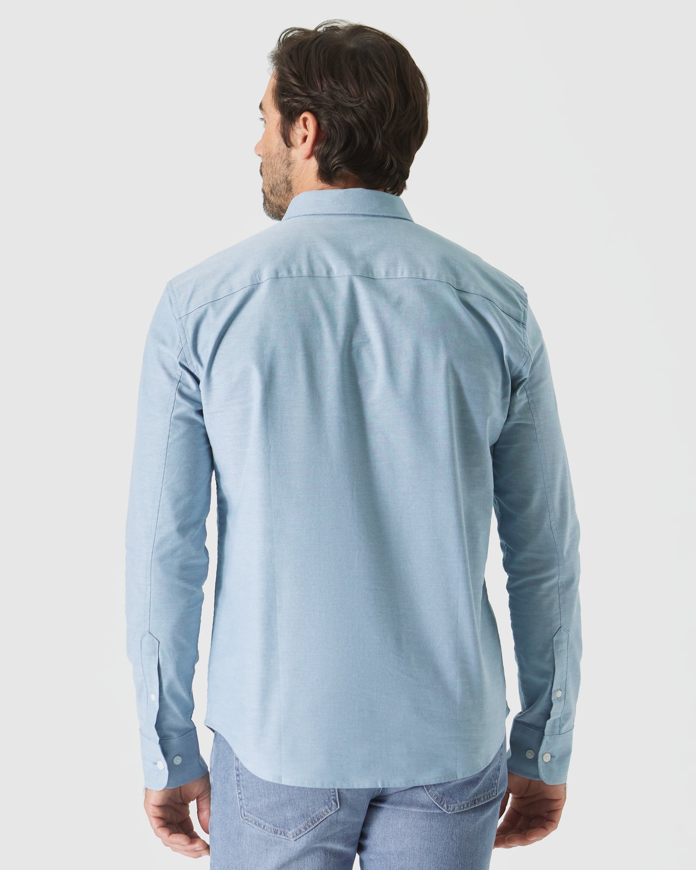 Rear view of man in Harbor Stretch Oxford Long Sleeve Shirt.