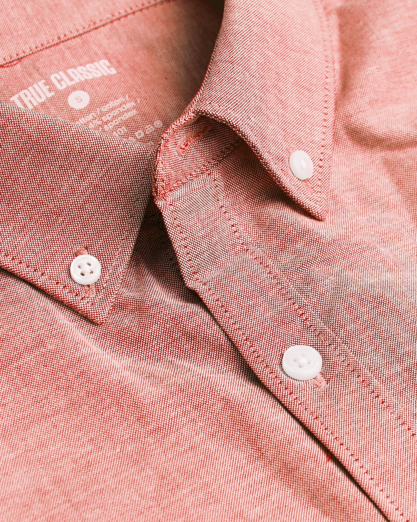 Peach Long Sleeve Oxford Shirt close-up with collar, white buttons visible.