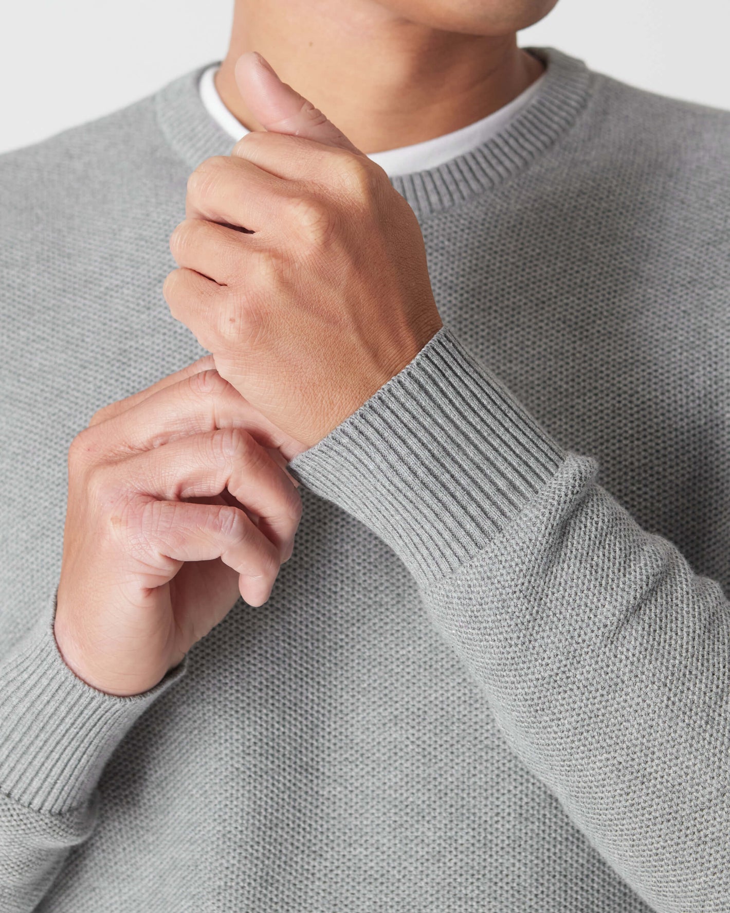 Heather Gray Pique Crew Sweater with ribbed cuffs and visible textured knit.
